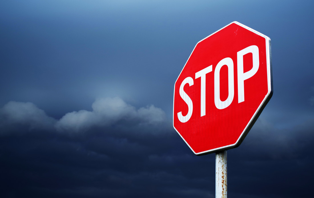 Stop sign and stormy sky