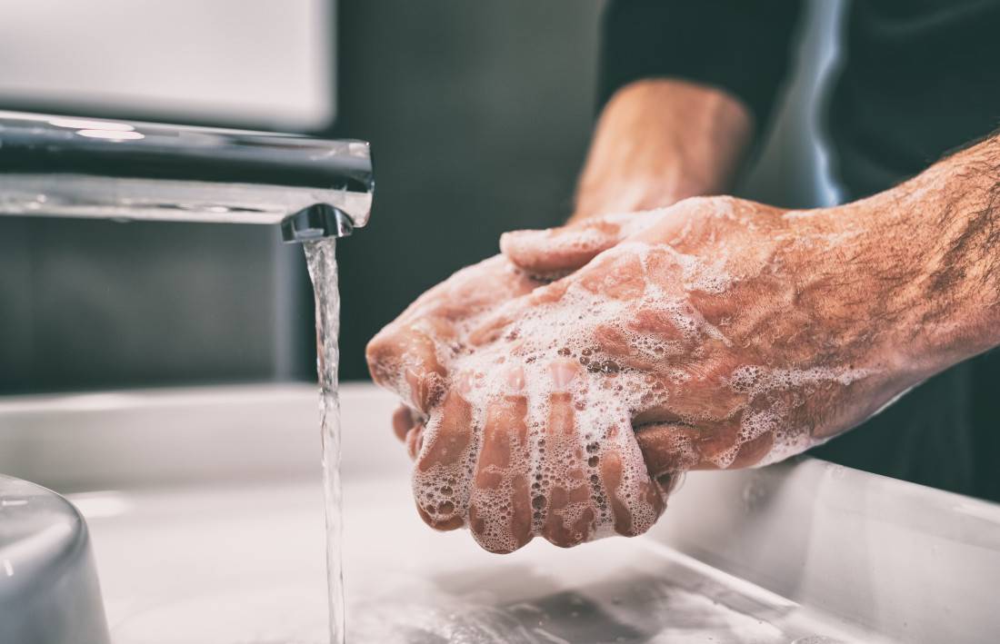 Man washing hands with soap and water