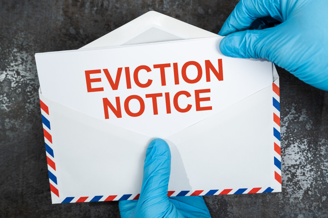 Eviction notice in red letters on white envelope