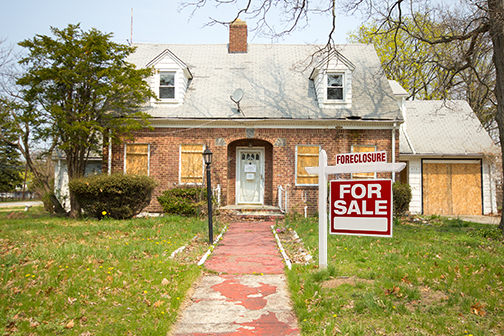 boarded up house in foreclosure for sale